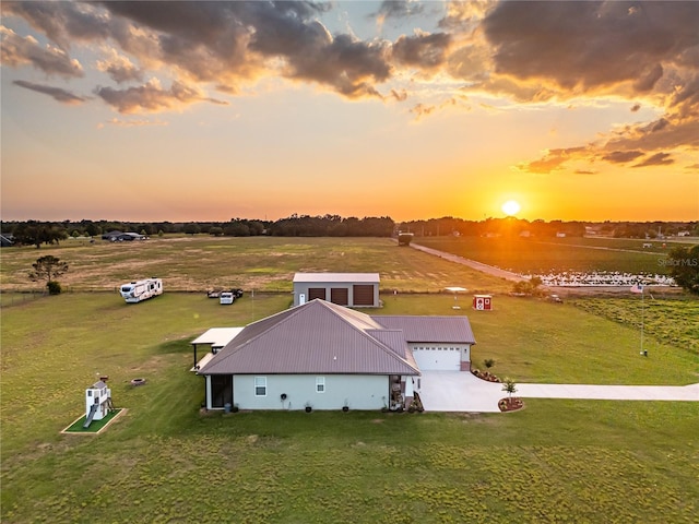 aerial view at dusk featuring a rural view