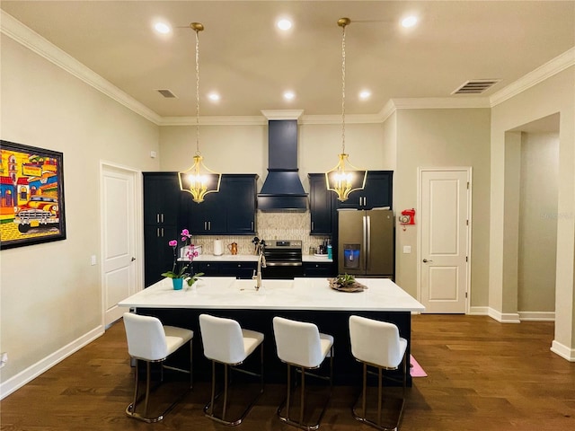 kitchen featuring premium range hood, a center island with sink, dark hardwood / wood-style floors, and appliances with stainless steel finishes