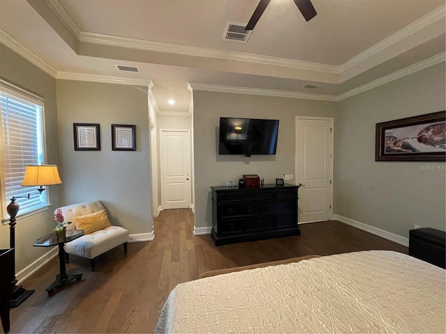 bedroom with ceiling fan, ornamental molding, and dark wood-type flooring