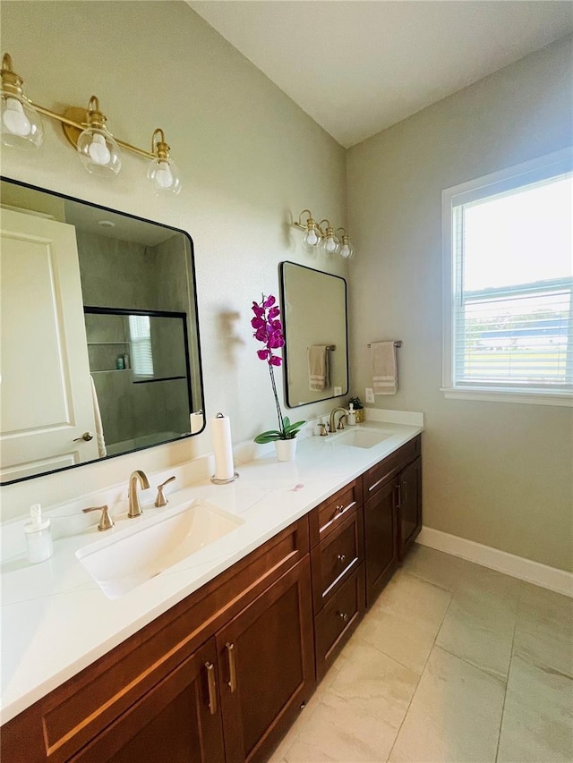 bathroom with tile patterned flooring, vanity, and an enclosed shower