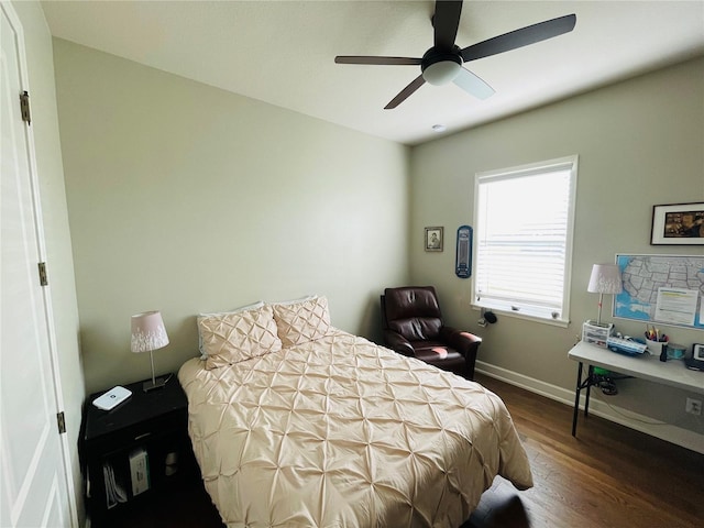 bedroom with ceiling fan and dark wood-type flooring