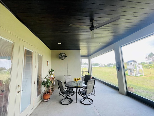 sunroom featuring ceiling fan and wood ceiling