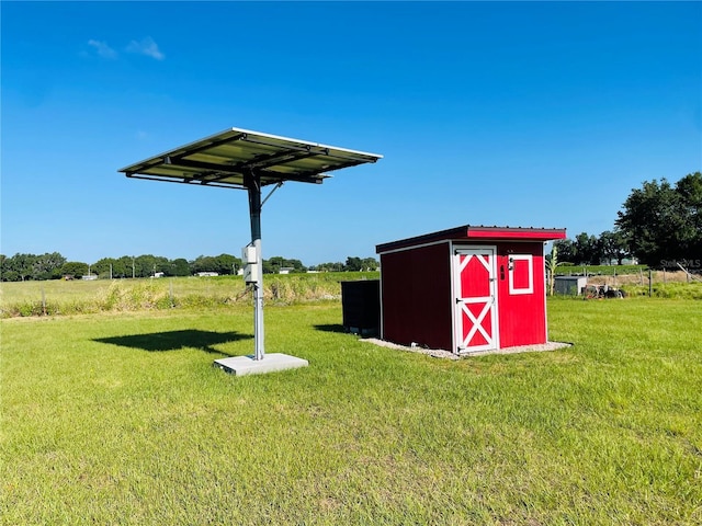 view of yard with a rural view and a storage shed