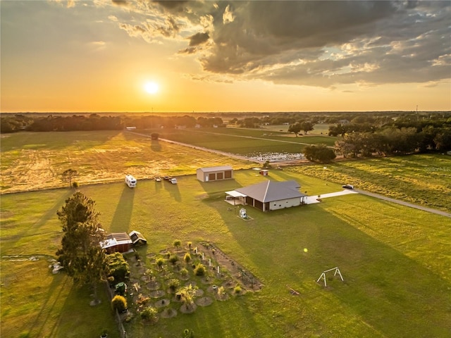 aerial view at dusk featuring a rural view