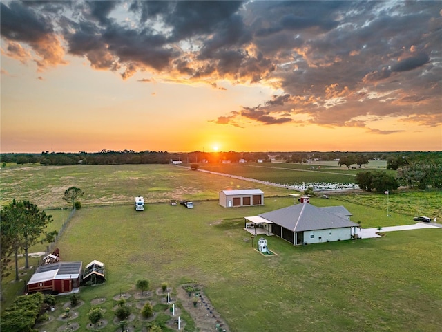 aerial view at dusk featuring a rural view