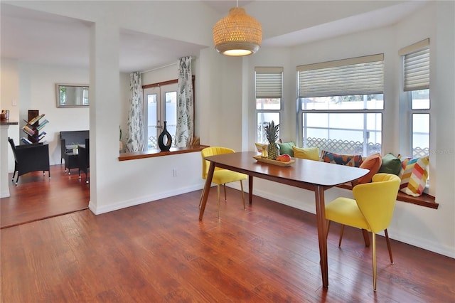 dining area with french doors, dark hardwood / wood-style flooring, and plenty of natural light