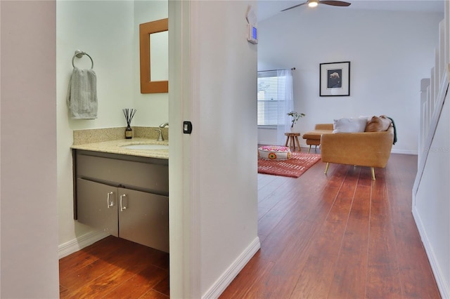 bathroom featuring hardwood / wood-style floors, vanity, ceiling fan, and vaulted ceiling