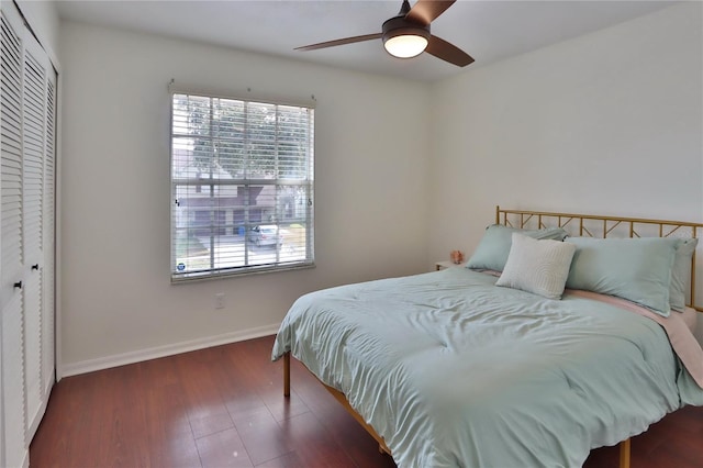 bedroom with ceiling fan, dark hardwood / wood-style flooring, and a closet