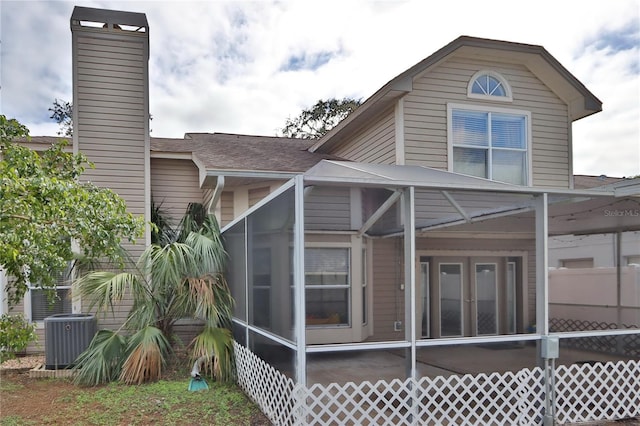 rear view of property featuring cooling unit