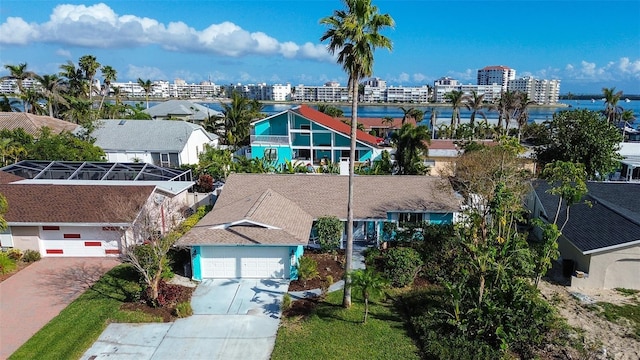 birds eye view of property featuring a water view and a city view