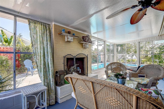 sunroom with a brick fireplace and a wealth of natural light