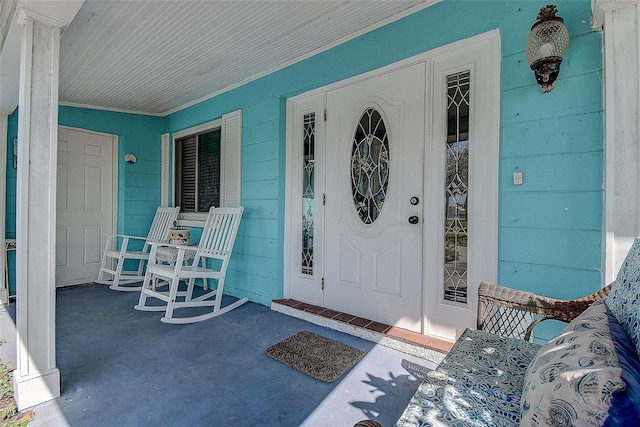 view of exterior entry featuring a porch