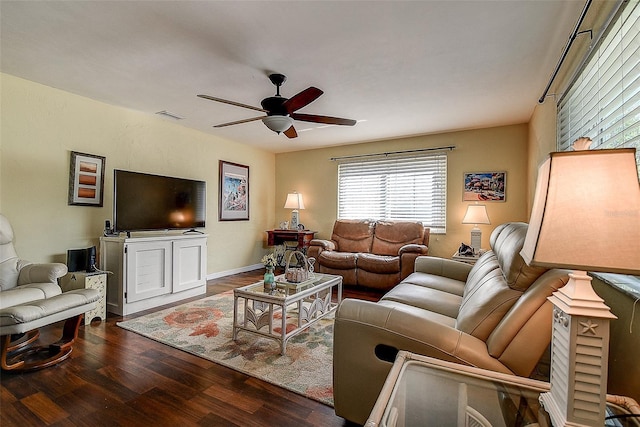 living room with a ceiling fan, baseboards, visible vents, and wood finished floors