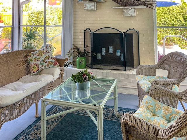 sunroom / solarium with a fireplace