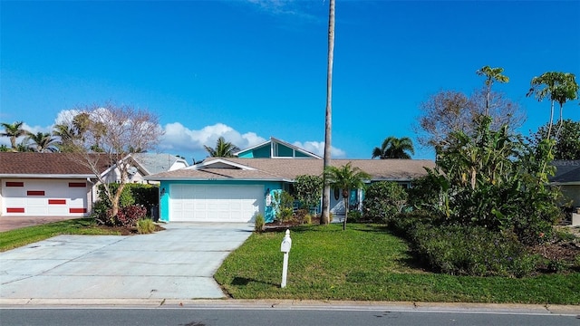 single story home with concrete driveway, a front lawn, and an attached garage