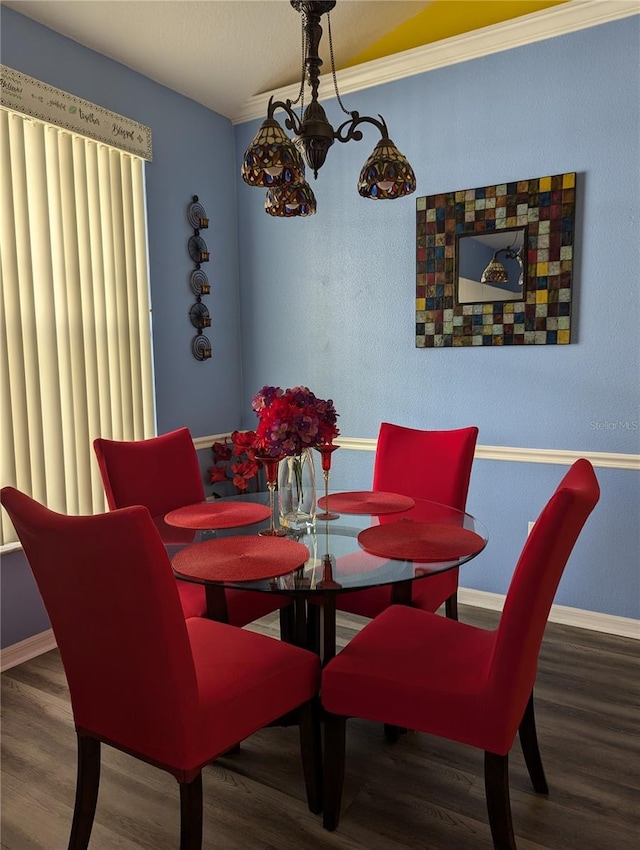 dining area featuring crown molding and hardwood / wood-style flooring