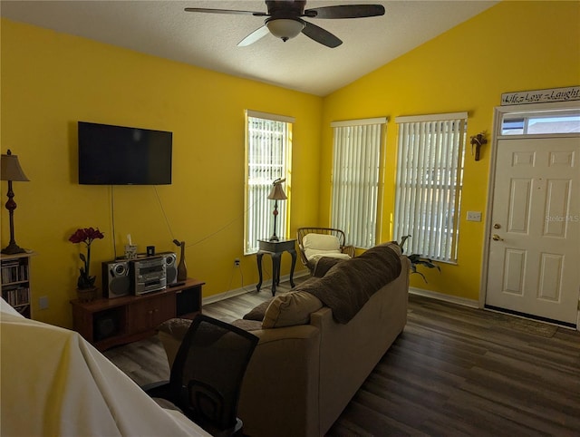 living room with a wealth of natural light, dark hardwood / wood-style flooring, and ceiling fan