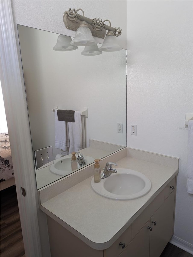 bathroom with vanity and wood-type flooring