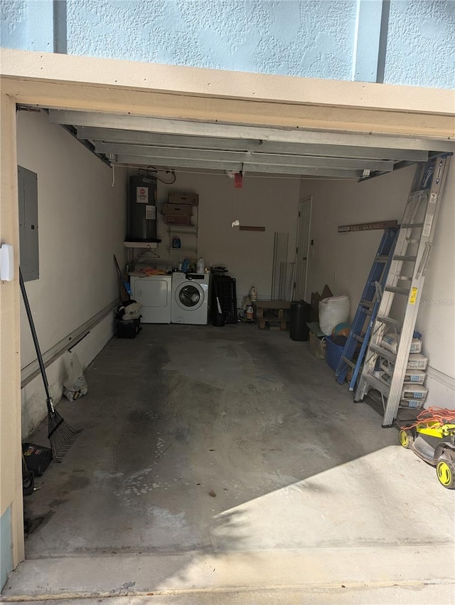 garage featuring electric panel, electric water heater, and washer and clothes dryer