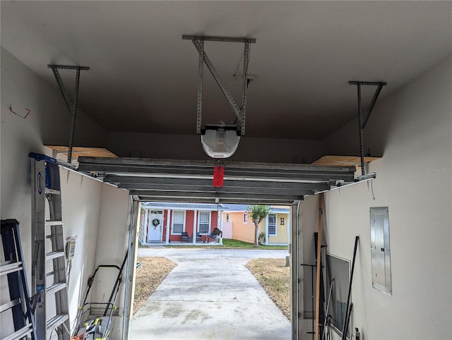 garage with electric panel and a garage door opener