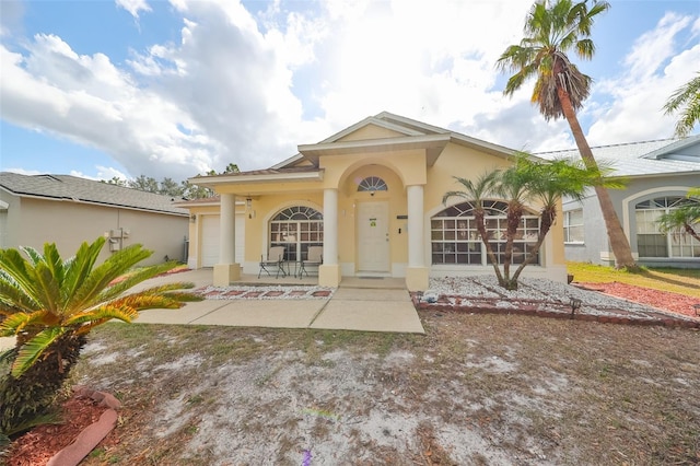 view of front of home featuring a porch and a garage