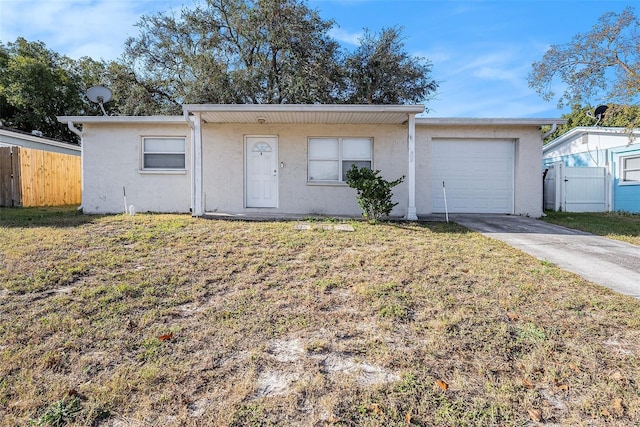 single story home featuring a garage and a front lawn