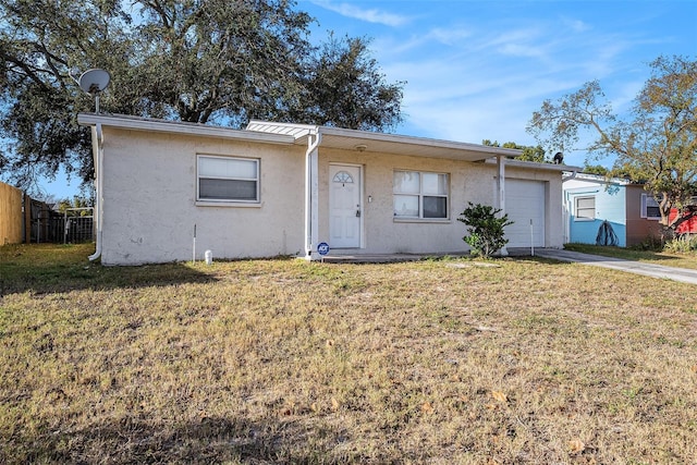 view of front of property featuring a garage and a front yard