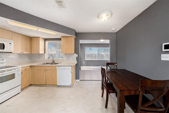 kitchen with white appliances, sink, decorative backsplash, a textured ceiling, and light brown cabinetry