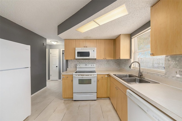 kitchen featuring a textured ceiling, decorative backsplash, white appliances, and sink