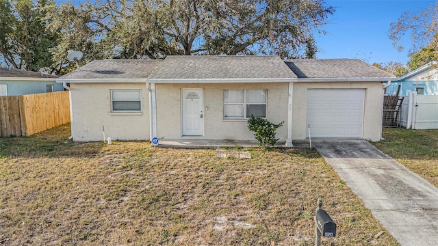 view of front of home with a garage and a front yard