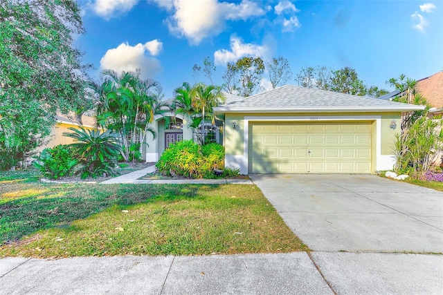 single story home with a garage and a front lawn