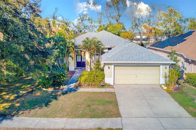 view of front of house featuring a front yard and a garage