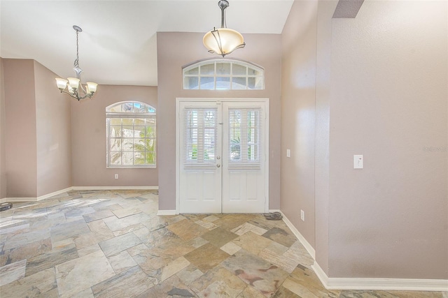 foyer entrance featuring french doors and a notable chandelier