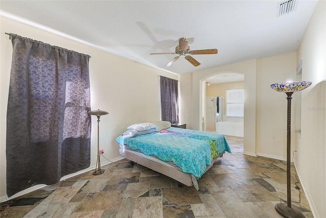 bedroom featuring ensuite bath and ceiling fan