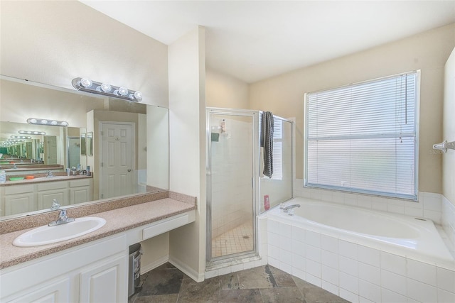 bathroom featuring vanity and independent shower and bath