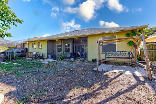 back of house featuring a sunroom