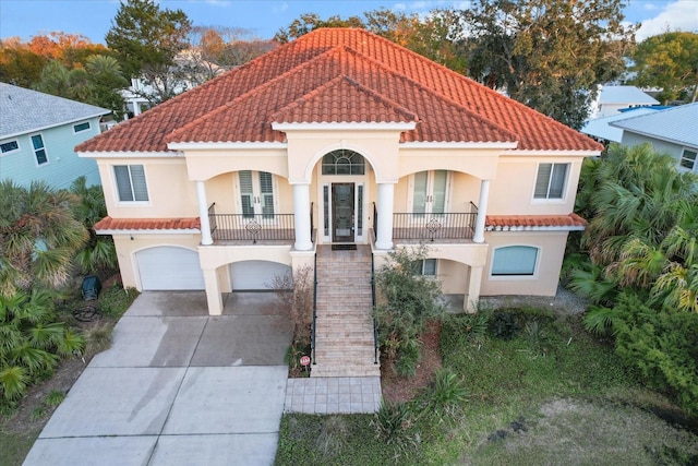 mediterranean / spanish house featuring french doors and a garage