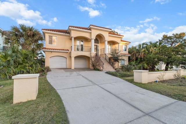 mediterranean / spanish-style home with a garage