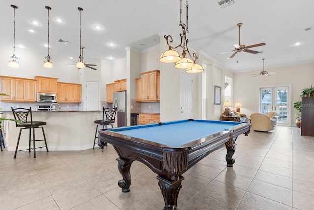 recreation room featuring ceiling fan, french doors, pool table, light tile patterned floors, and ornamental molding