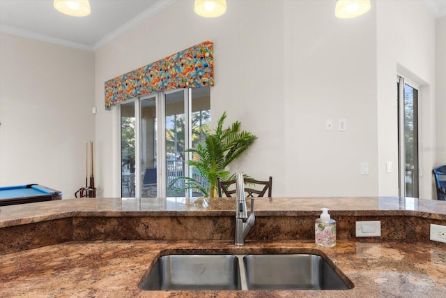 kitchen featuring plenty of natural light, ornamental molding, sink, and billiards