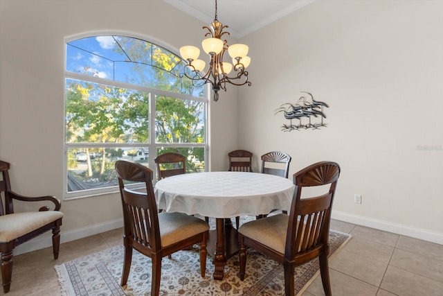 dining space featuring light tile patterned floors, crown molding, a wealth of natural light, and a chandelier