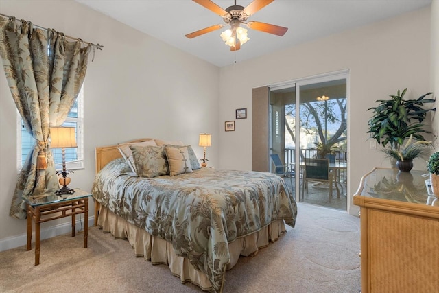 carpeted bedroom featuring access to exterior, multiple windows, and ceiling fan