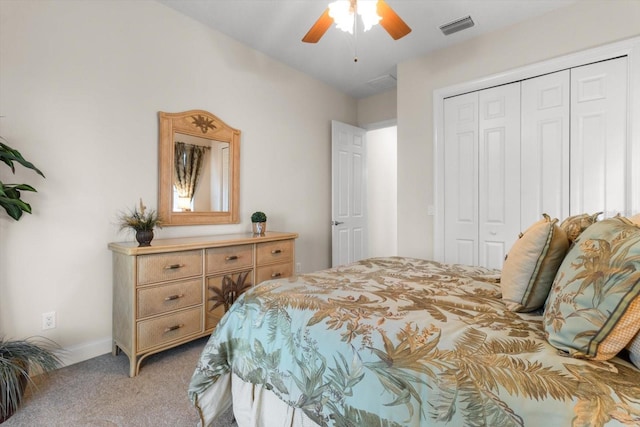 carpeted bedroom featuring ceiling fan and a closet