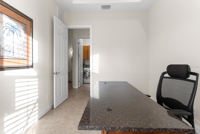 tiled home office with washer / clothes dryer