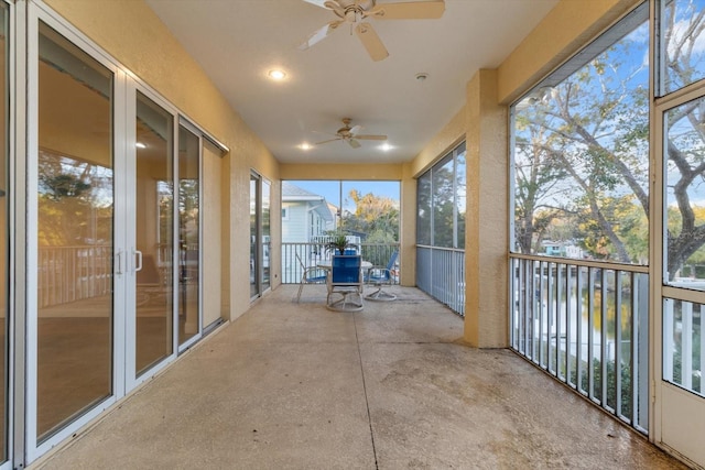 unfurnished sunroom featuring plenty of natural light and ceiling fan