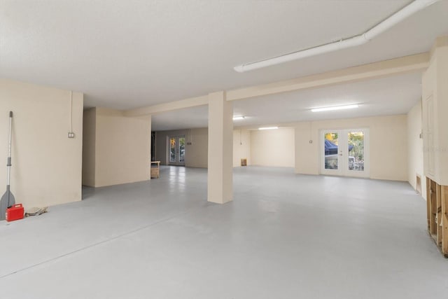 interior space with a textured ceiling and french doors