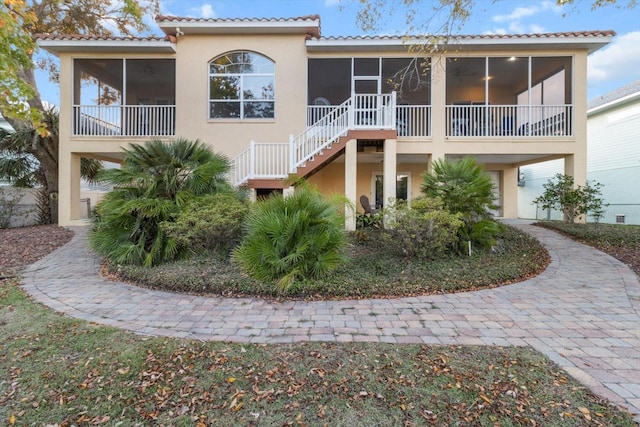 back of property with a sunroom