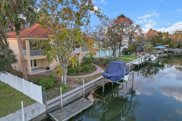 view of dock with a patio and a water view