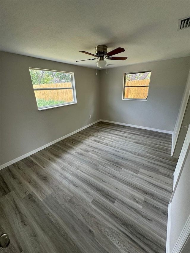 unfurnished room featuring hardwood / wood-style floors and ceiling fan