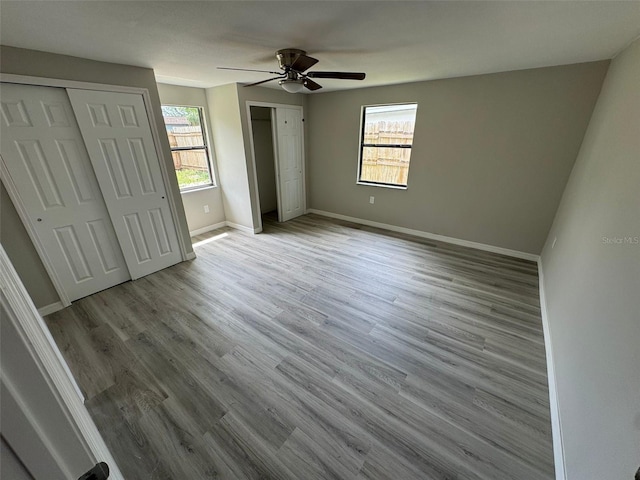 unfurnished bedroom featuring ceiling fan and light wood-type flooring